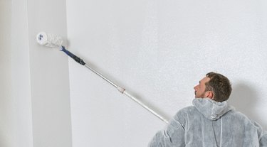 Man painting with a roller.