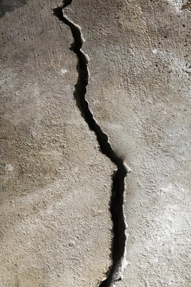 Close-up of a half-inch crack in a poured cement floor, background image