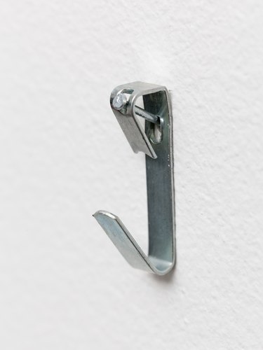 Macro of steel picture hook nailed to wall