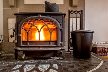 High efficiency cast iron wood stove burning firewood