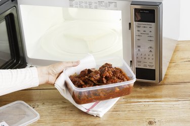 Removing leftovers from microwave.