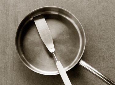 empty stainless steel frying pan and spatula