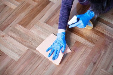 Woman cleaning parquet floor