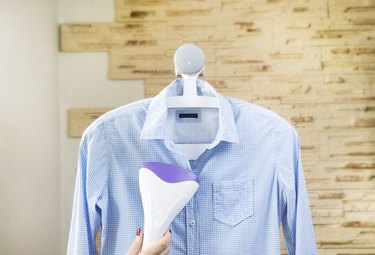 Ironing a shirt with a clothes steamer