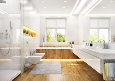 Modern white bathroom with wooden floor.