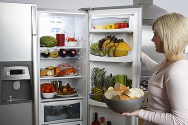 Woman opening a fridge