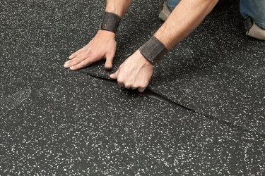 Worker Installing Recycled Rubber Floor