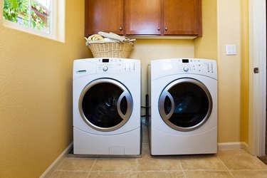 White modern washer and dryer in home's laundry room.