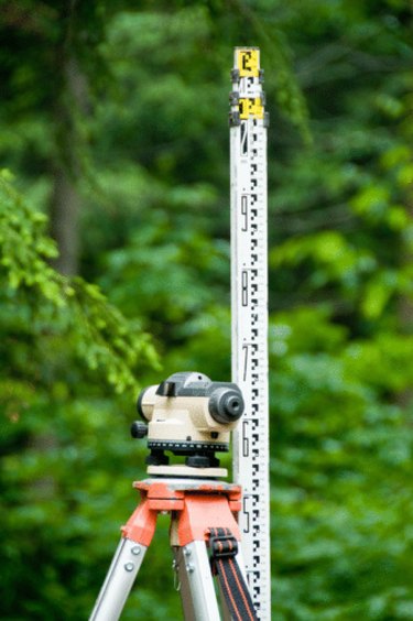 A transit and measuring stick are used to determine the grade or slope of land
