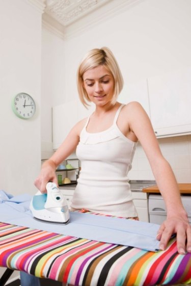 Woman ironing fabric