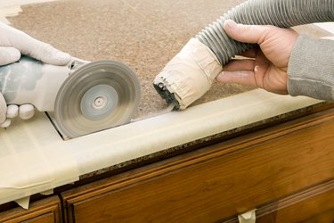 Workers Cutting Sink Hole in a Granite Countertop