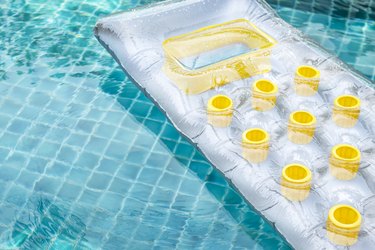 Inflatable swimming pool air mattress floating on clear swimming pool water