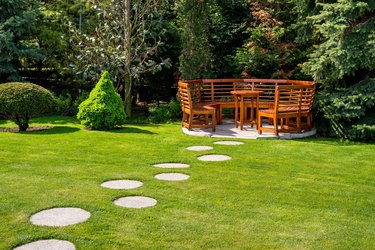 Sunny day in a spring garden with wooden benches