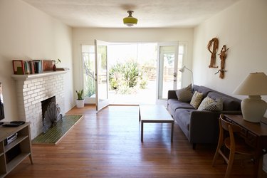 Interior Of Modern Lounge With Open French Windows To Garden