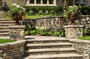 Natural stone landscaping of walls and steps outside house