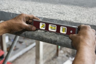 Close-up of a person's hand holding a level