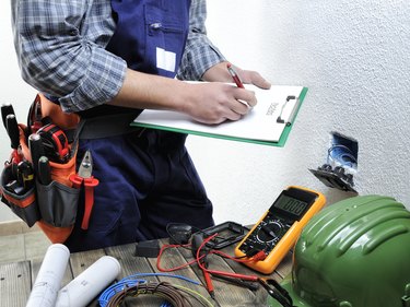 Young electrician working in a residential electrical installation