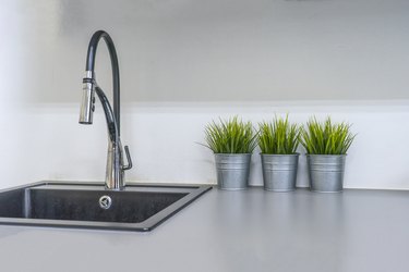 Kitchen sink and faucet in house interior.