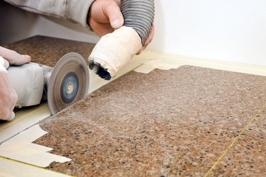 Workers Cutting Sink Hole in a Granite Countertop