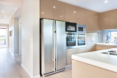 Modern refrigerator in the luxury kitchen with microwave ovens