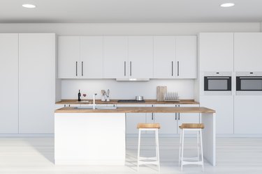 Modern white kitchen interior with bar