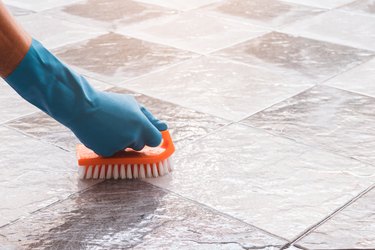 Cleaning the tile floor.