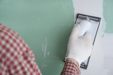 Sanding the drywall mud