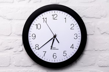 Wall clock on white brick wall