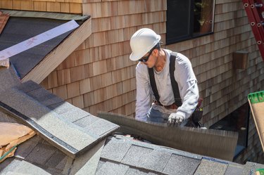 Man installing asphalt roof