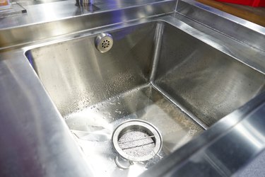 Faucet in modern kitchen into sink