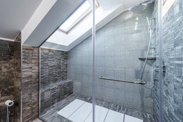 Glass shower cabin in modern loft bathroom