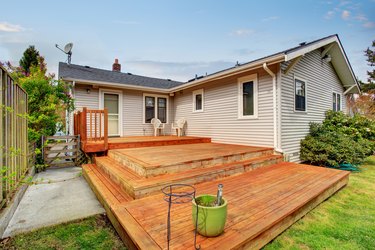 Picture of Large wooden back deck with two chairs.