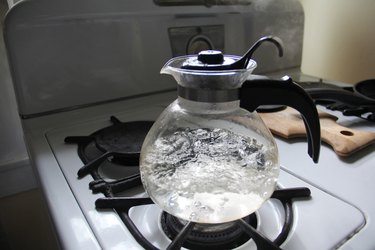Water boiling in a whistling tea kettle