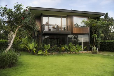 Modern design house surrounded by lush tropical garden