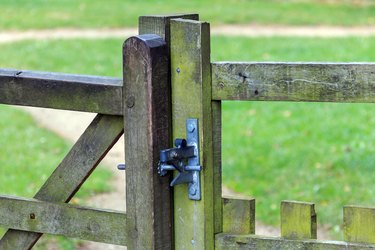 Metal gate latch fitted to wooden gate and post