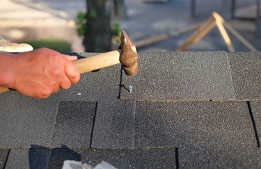 Contractor  nailing shingles.