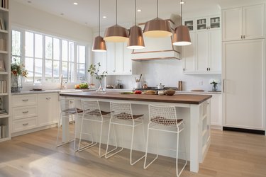 White home showcase interior kitchen with copper pendant lights