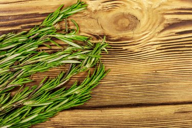 Fresh rosemary herbs on a wooden table. Top view