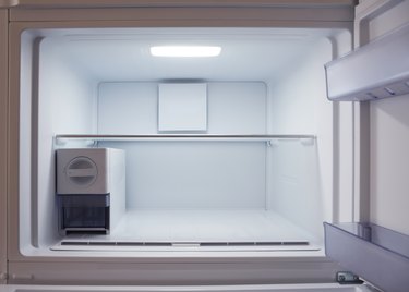 Inside of empty and clean modern refrigerator, freezer