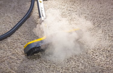 A steam cleaner in action cleaning a carpet