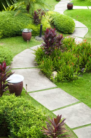 Concrete path through a green garden