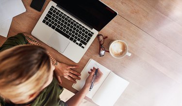 Woman making to do list on diary