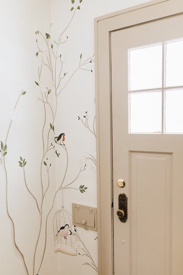 Hand-painted wallpaper in small entryway by She She