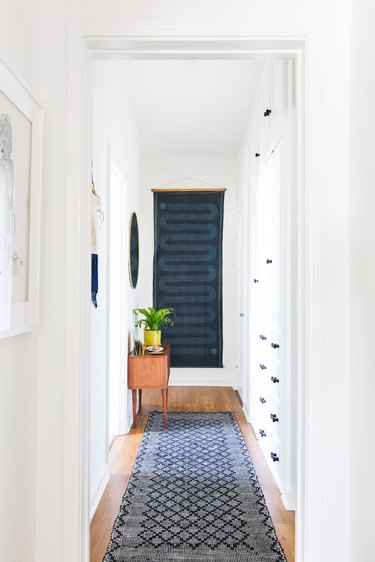 Small entryway with statement art by Emily Henderson Design