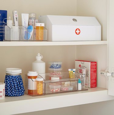 Medicine Cabinet Organization ideas in Medicine cabinet with first aid kit, clear organizers, pills.