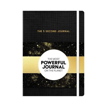 black and gold journal with white circle