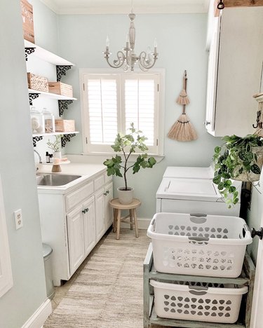 Budget-Friendly Small Laundry Room Ideas in mint green laundry room with open shelving