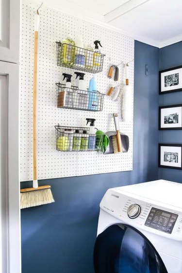 Budget-Friendly Small Laundry Room Ideas in navy blue laundry room with peg board