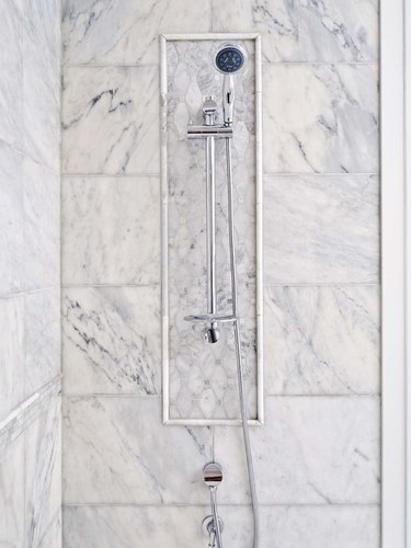 traditional shower fixtures with marble tile surround