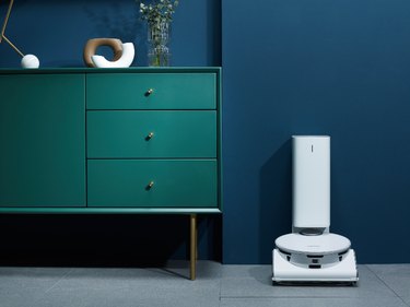dark green dresser with high-tech vacuum next to it